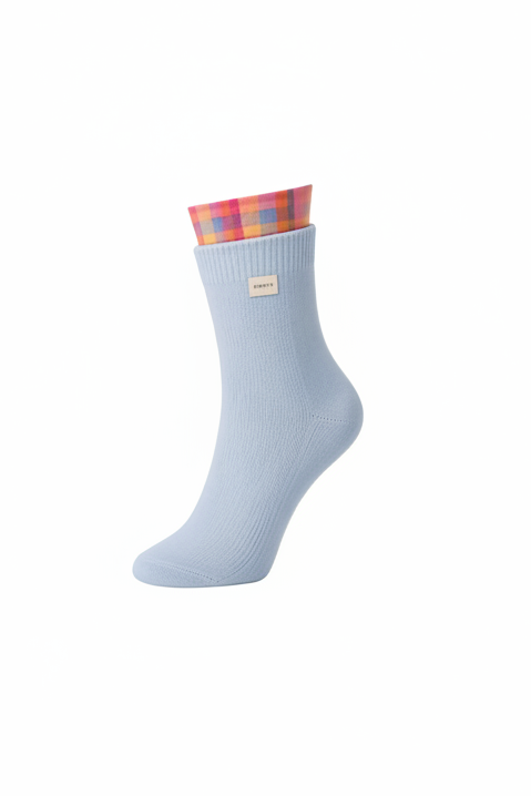 Light blue sock with a colorful cuff on a white background